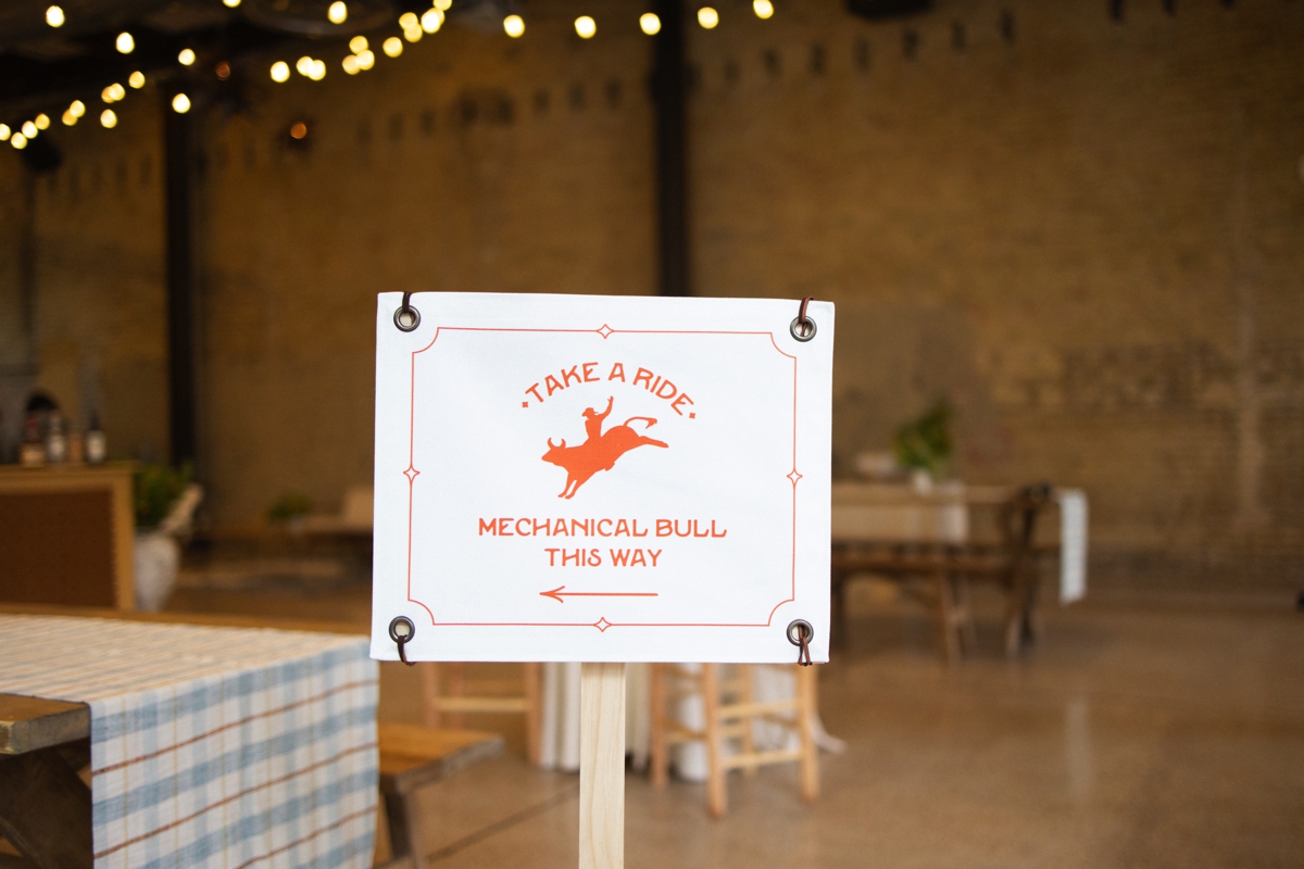Welcome party signage at 800 Congress in Downtown Austin with mechanical bull and fun events for guests as they arrived for M+J's wedding weekend! | Owl & Envelope | Austin Luxury Wedding Vendor